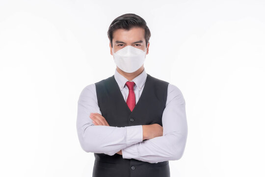 Stop Covid-19 , Asian man with suit standing arms crossed wearing Face Mask protect spread Covid-19 Coronavirus on white background