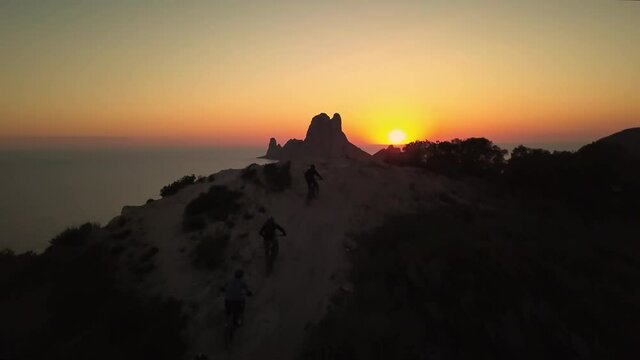 Epic mountain bikers view of breathtaking Es Vedra, golden hour, drone