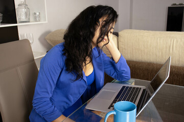 A depressed executive reading the reports of her work group, dressed in blue and with a blue coffee...