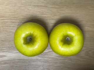 yellow green apples on oak table