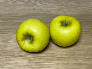 yellow green apples on oak table