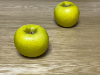 yellow green apples on oak table