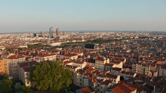 Descending drone shot of Lyon France glowing in the sunset light