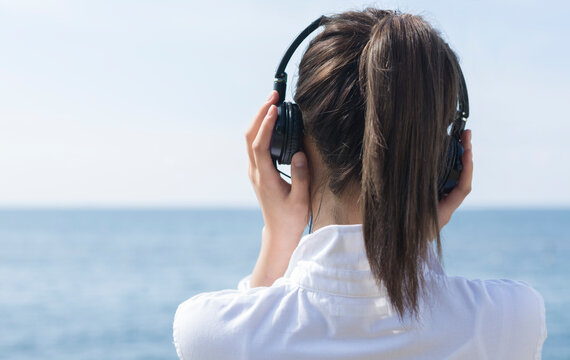 ヘッドホンで音楽を聴く女性