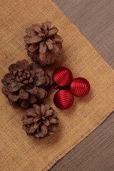 Christmas ornaments on burlap and wooden table. Rustic style.