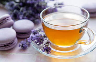Cup of tea with macaroon dessert with lavender flavor