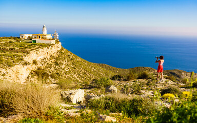 Fototapeta na wymiar Tourist take photo at lighthouse, Cabo de Gata, Spain