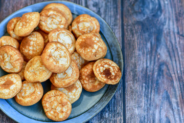 Homemade Dutch Poffertjes  Mini Pancakes with butter , Powdered Sugar  and blueberries