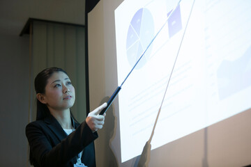 会議で説明をするビジネスウーマン