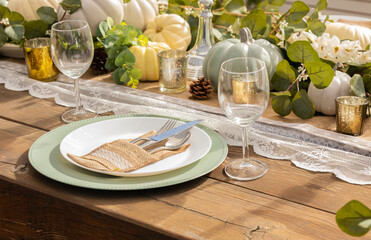 Autumn and Thanksgiving table decoration with white mini pumpkins