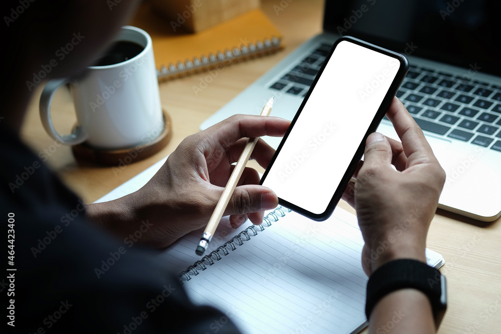 Poster close up view man holding mock up smart phone with white screen..