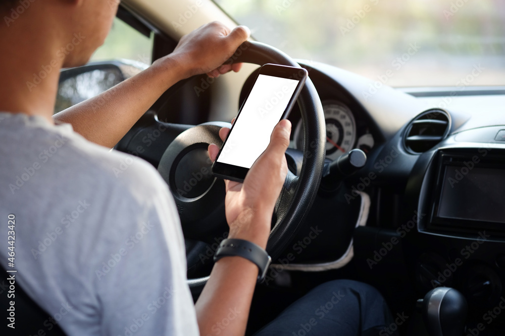 Poster cropped shot view the driver uses the phone while driving. modern smart phone with round edges. isol