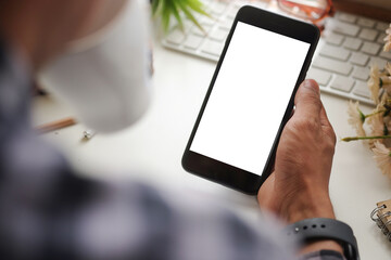 Man holding mock up smart phone. Blank screen for your text message or information content.