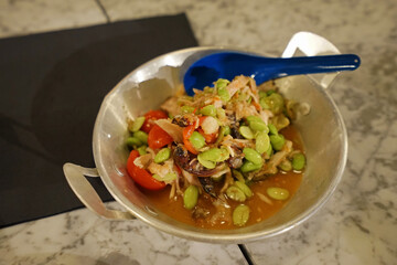 Close up spicy Thai papaya salad(Som Tum) with Japanese edamame beans and salted crab