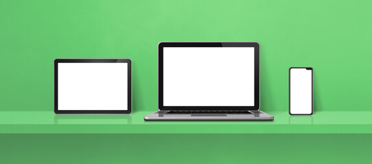Laptop, mobile phone and digital tablet pc on green wall shelf. Banner background