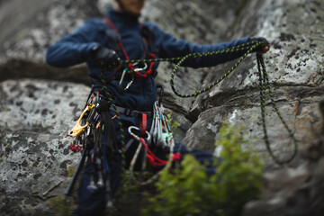 Climber works with a rope during the ascent, unsharp silhouette, face is not visible.
