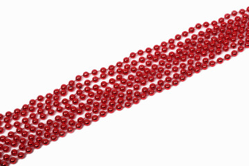 red beads on a white background, the concept of the Mardi Gras holiday