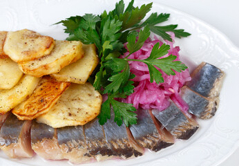 Photo of pickled herring with potato and onion, top view