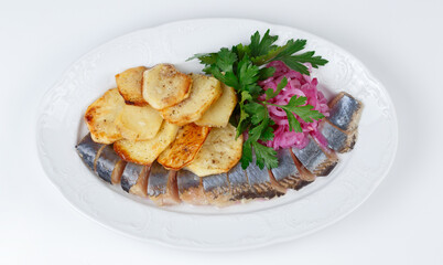 Image of pickled herring with potato and onion, top view