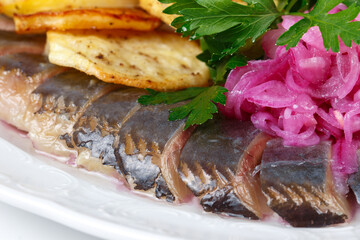 Image of pickled herring with potato, parsley and onion