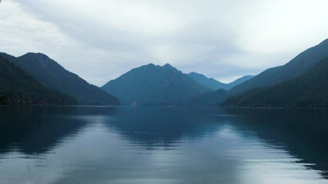 Scenic Lake Crescent filmed in slow motion with blue hued Olympic Mountains in background