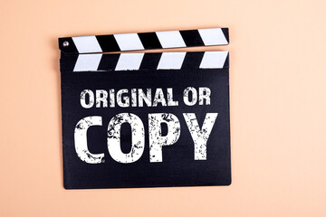 Original or Copy. Movie clapper board with text on a light background