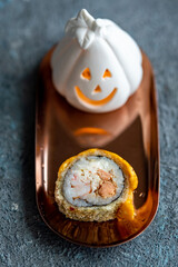 Fototapeta na wymiar Halloween sushi rolls on the table