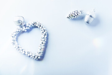 Christmas ornaments on bright paper background. Top view. Close up. Copy space.