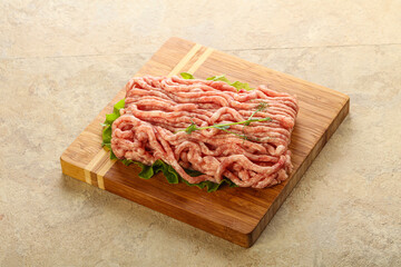 Raw minced pork meat over board