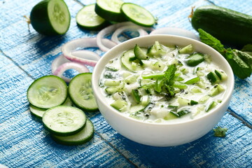 Bowl of delicious yogurt raitha salad with cucumber and onions.