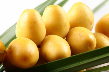 Fresh raw green date fruits, close up, macro image.