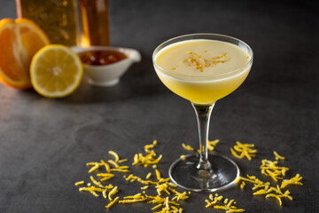 Luxury cocktail with lemon and tequila on a dark stone background