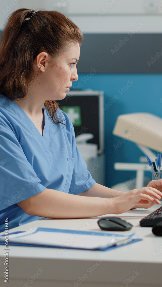 Poster nurse typing on computer keyboard for consultation and appointment. medical assistant using technolo