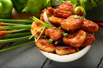 Delicious street foods background- crispy fried spicy nuggets with salads. 