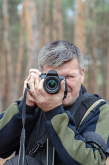 Obraz premium Portrait of a Photographer. A middle-aged man looks into the cam