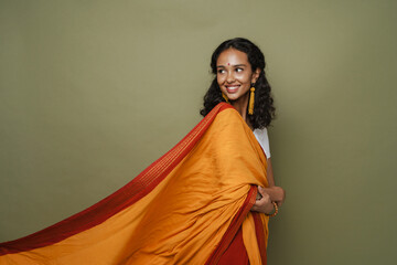 Young south asian woman wearing sari smiling while looking aside