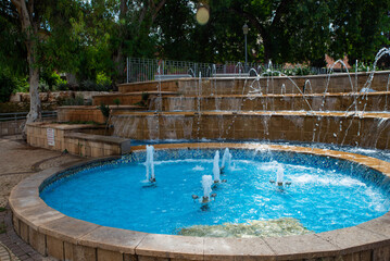 Fountains and palms in city garden park in Israel, Rishon Lezion. Summer landscape