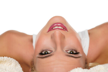 inverted portrait of a young lying blond smiling woman