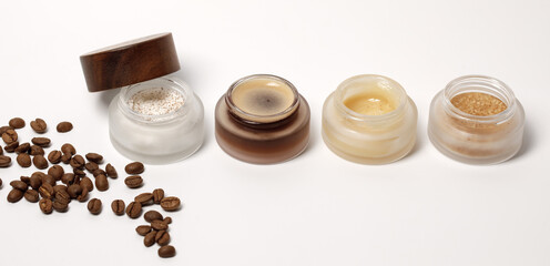 Obraz na płótnie Canvas Brown sugar, coffee and honey ingredients for scrub in glass jars with wooden lid for homemade cosmetic on background. Beauty, Spa, skin care, zero waste packaging concept