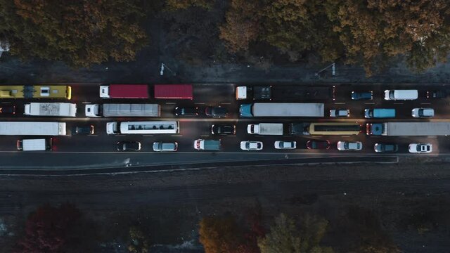 Direct view from above to the road traffic at night. Traffic jam at a highway junction. Aerial Drone Flight top down View of freeway busy city at night, rush hour heavy traffic jam highway.	