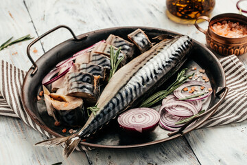 marinated mackerel or herring fish with salt, onion and spices on a metal tray. Seafood concept. top view