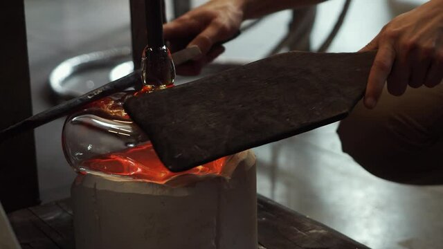 Glass blowing art and flame. Handmade glassware is produced on high fire.