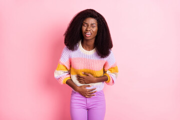 Portrait of unsatisfied dark skin person closed eyes hands on belly feel bad isolated on pink color...