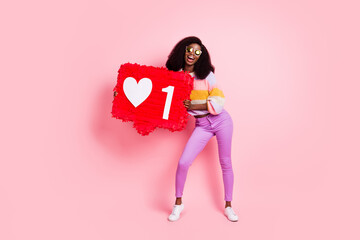 Full length photo of young afro girl happy positive smile hold paper pinata like heart icon...