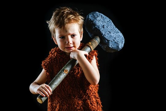 Little funny angry warrior boy. Neanderthal or a Cro-Magnon. Ancient caveman,   black.