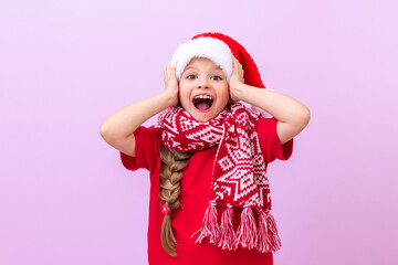 A little beautiful girl grabbed a New Year's hat and is very happy about the onset of the holidays.