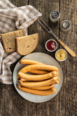 Smoked frankfurter sausages on plate.