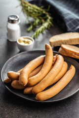 Smoked frankfurter sausages on plate.