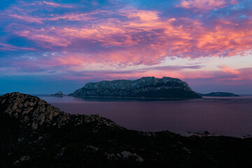 View from above, stunning aerial view of Tavolara Island during a dramatic sunset. Picture taken from Capo Ceraso, Sardinia, Italy.