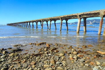 The historic wharf at Tokomaru Bay, New Zealand, built in the 1940s. The wharf's remarkable length is due to the shallowness of the bay 